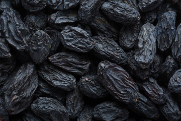  Close up of big black Raisins. Top view.  Selective focus.