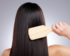 Girl, back and hair care in studio with brush for hairdresser and beauty salon on white background. Model, comb and confident with healthy texture, wellness or treatment with growth transformation