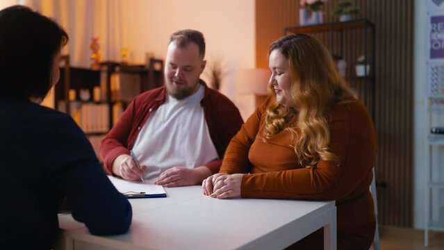 Happy couple signing contract with travel agent, vacation planning, insurance
