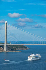 Obraz premium Big cruiser passanger ship crossing the Bosporus from Istanbul to the Black Sea crossing the Sultan Selim Bridge