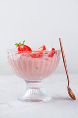 Whipped tofu and strawberry mousse dessert with berries in a glass. Vegan food. Vertical orientation.