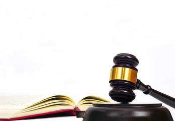 Close up of judge gavel on law book in white background. Lawyer, law, justice system, hammer auction.