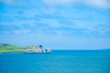 Fototapeta premium Dublin, Ireland - seaside under blue sky and white clouds
