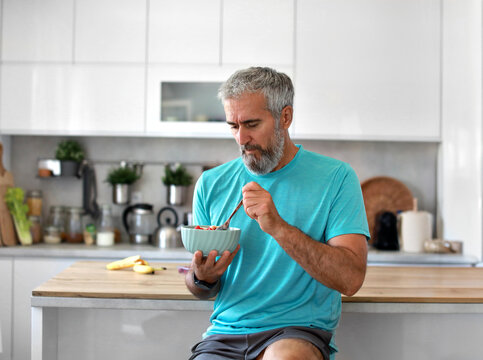 kitchen food man healthy morning mature breakfast active fitness diet home healthy eating senior adult healthy lifestyle fruit sport fit health eating preparation nutrition male