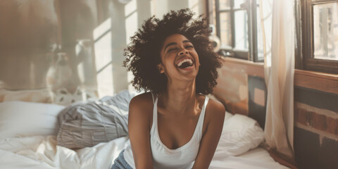 Woman laughing joyfully in cozy indoor setting