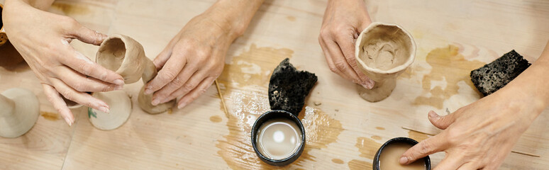 Two women craft pottery together in a cozy studio.