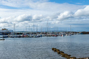 Obraz premium Scotland Kirkwall marina full of yachts with a lighthouse on an overcast afternoon 