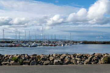 Scotland Kirkwall marina full of yachts with a lighthouse on an overcast afternoon 