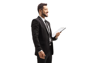 Elegant man in a black suit holding a clipboard