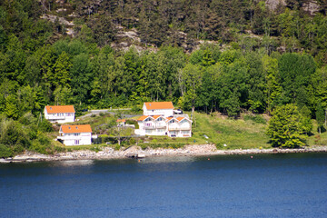 the Inner Oslofjord, near Oslo, Norway on a clear day with dark blue sea and sky with wooded hills and red roof houses