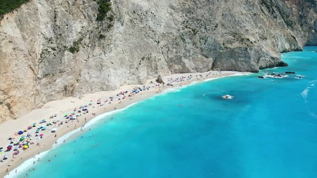 An aerial view of Porto Katsiki beach in Lefkada, Greece, showcasing its stunning white sand, turquoise waters, and dramatic cliffs.