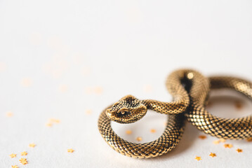 Bronze snake figurine on a white background. The symbol of 2025. Happy Chinese New Year.