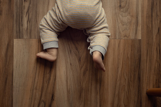 baby crawling on a parquet board or laminate, 0-1 year old baby skills