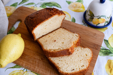 Slices of lemon pie on  wooden board with lemon and lemongrass. A simple recipe for citrus dessert for every day. Homemade baking. Top view, flatlay. Selective focus..