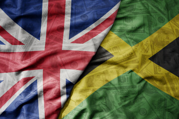 big waving colorful flag of jamaica and national flag of great britain on the dollar money...