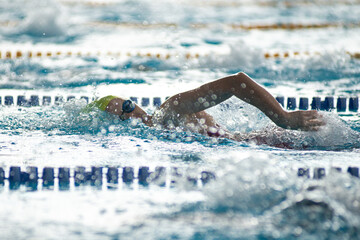 Swimmer swims freestyle swimming style in the pool