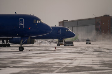 Parked airplane at the airport in winter. 