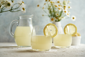 Natural whey in two glasses and a jug - protein rich healthy nutritional supplement