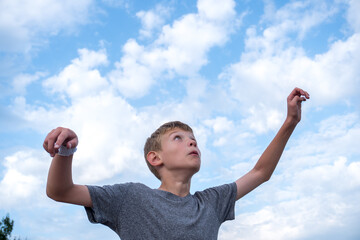 a boy kicks and prepares to head a soccer ball