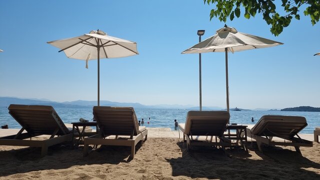 beach sea umbrellas sun beam summer vacation corfu island dassia beach