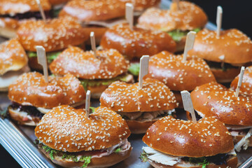 Beautifully decorated banquet catering table, with variety of with different food snacks appetizers on corporate birthday party event or wedding celebration, canape, salad, delicatessen setting