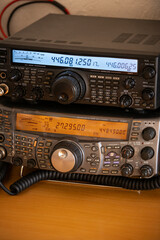 Two radio receivers stacked on top of each other.