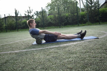A young man in sportswear engages in a workout, using a sport tool for physical exercises on a...