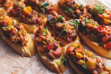 Beautifully decorated banquet catering table, with variety of with different food snacks appetizers on corporate birthday party event or wedding celebration, canape, salad, delicatessen setting