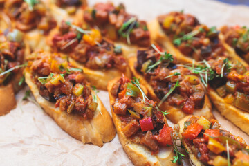 Beautifully decorated banquet catering table, with variety of with different food snacks appetizers on corporate birthday party event or wedding celebration, canape, salad, delicatessen setting