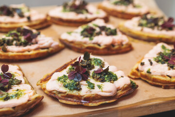 Beautifully decorated banquet catering table, with variety of with different food snacks appetizers on corporate birthday party event or wedding celebration, canape, salad, delicatessen setting