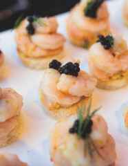 Beautifully decorated banquet catering table, with variety of with different food snacks appetizers...