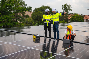 Male Solar engineer team working together with solar panel system on roof