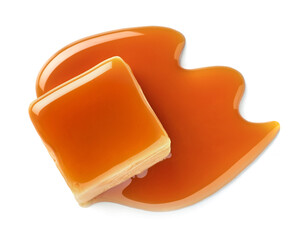 One sweet caramel candy cube topped with caramel sauce on white background.