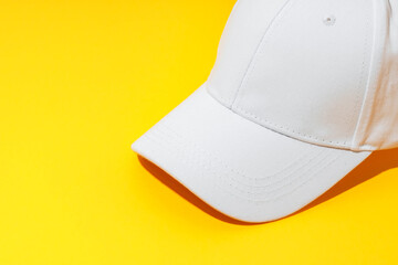 Baseball hat against yellow background in studio