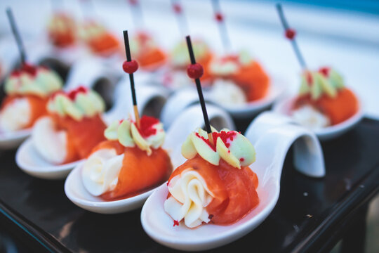 Beautifully decorated luxury banquet catering table, with variety of with different food snacks appetizers on corporate birthday party event wedding celebration, canape, salad, delicatessen variety