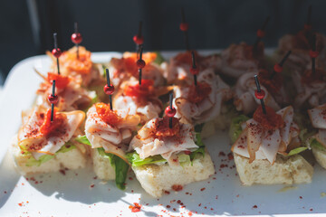 Beautifully decorated luxury banquet catering table, with variety of with different food snacks appetizers on corporate birthday party event wedding celebration, canape, salad, delicatessen variety