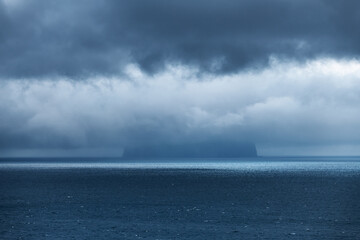 Koltur Island Hidden by Storm Clouds in the Atlantic Ocean. Faroe islands, Denmark. Landscape photography