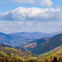 Fototapeta premium green mountain valley under blue cloudy sky