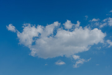 Single white cloud in a clear blue sky