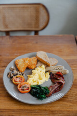 Delicious full English breakfast served on a rustic wooden table