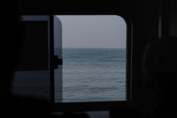 View of the calm sea through a window