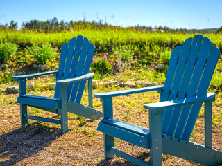 Two Blue Cape Cod Adirondack Chairs on the Meadow