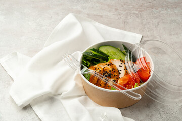 Tasty poke bowls on gray textured surface