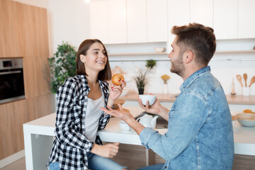 young happy man and woman in kitchen, breakfast, couple together in morning