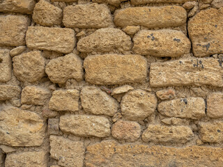 Old houses made of shell stone. The stone walls of the house are made of limestone blocks. The streets are paved with slabs of natural stone. The quarters of the ancient city with narrow streets.
