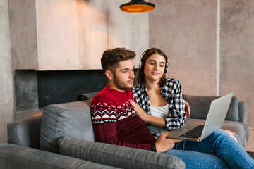 young pretty man and woman sitting at home