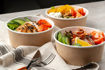 Beautiful composition with poke bowls on gray background with napkin