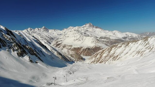Aerial video over ski resort and snowy mountains in Gudauri Georgia
