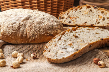 Traditional sourdough bread with nuts and raisins on canvas fabric