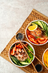 Fresh poke bowl on straw mat close up